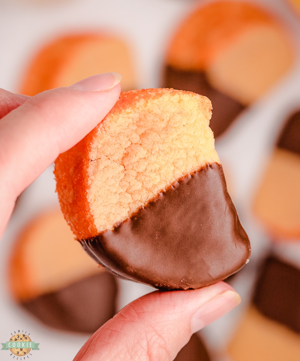 holding an orange slice cookie