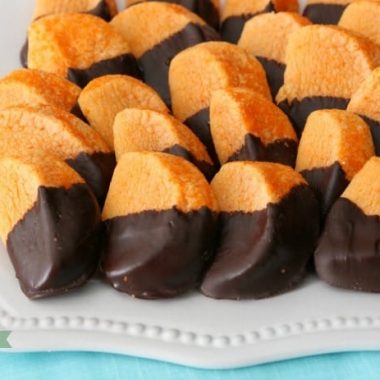 Chocolate Orange Slice Cookies mimic orange slices dipped in chocolate. Bright, tangy citrusy flavor comes from orange Kool-Aid mix baked into the cookies! Perfect cookie recipe for cookie exchanges and during the holidays. 