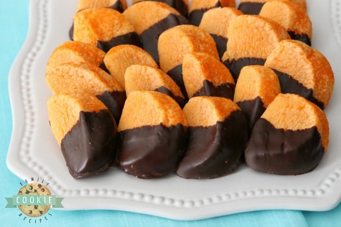 Chocolate Orange Slice Cookies mimic orange slices dipped in chocolate. Bright, tangy citrusy flavor comes from orange Kool-Aid mix baked into the cookies! Perfect cookie recipe for cookie exchanges and during the holidays. 