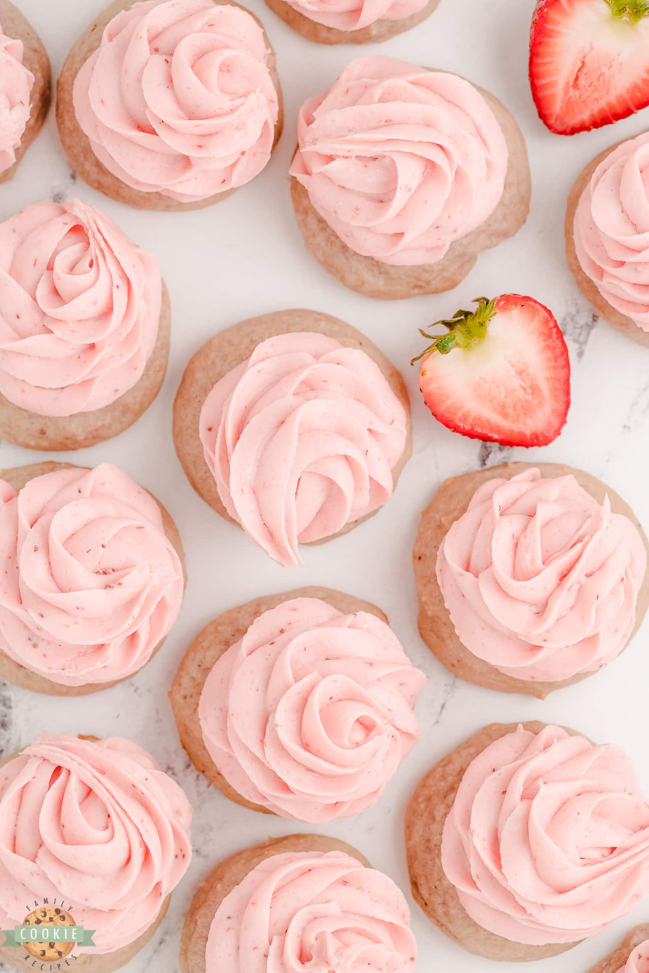 strawberry cookies topped with strawberry buttercream rosettes