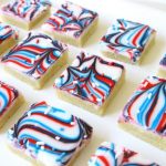 Fun Patriotic Cookie Bars made with swirled red, white & blue icing making them perfectly festive! Easy sugar cookie bar recipe for 4th of July & Memorial Day.