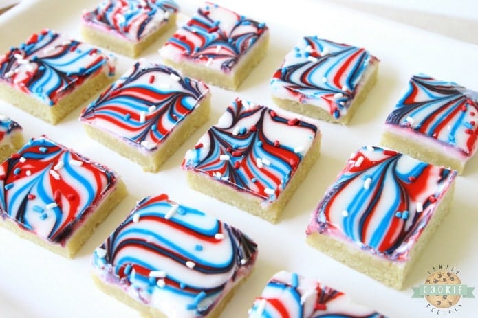 Fun Patriotic Cookie Bars made with swirled red, white & blue icing making them perfectly festive! Easy sugar cookie bar recipe for 4th of July & Memorial Day.