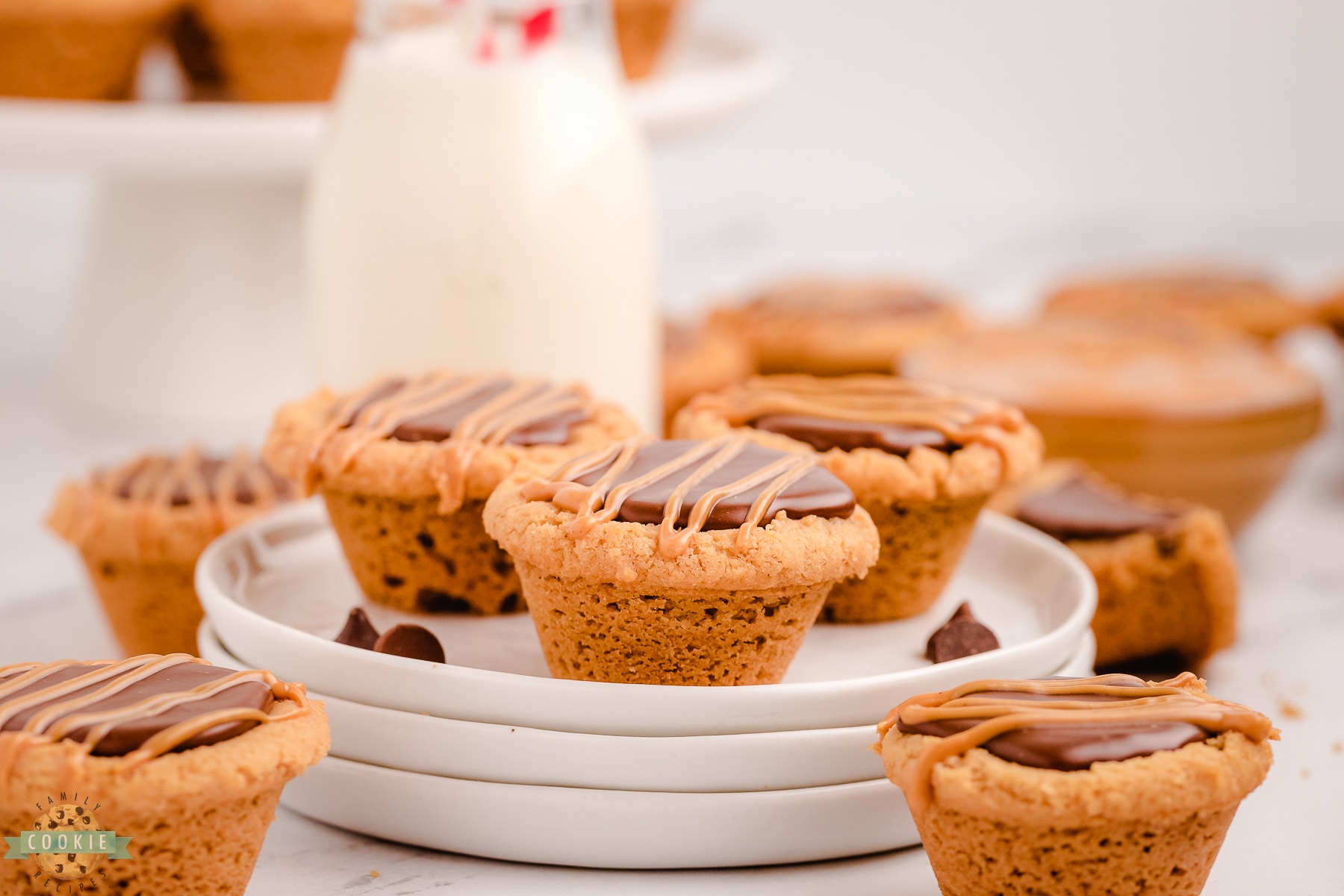fudge peanut butter cookie cups on a white plate with milk