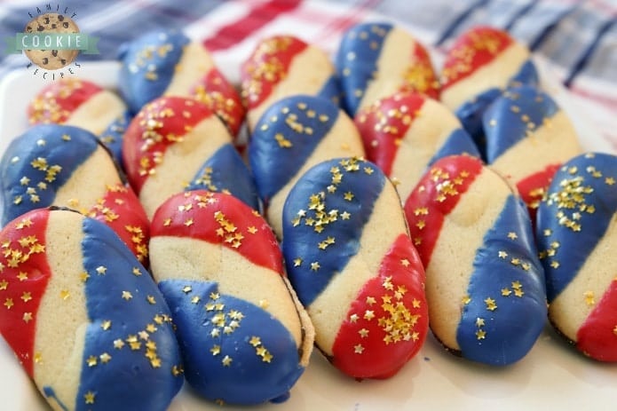 Super Simple 4th of July Cookies made with just 4 ingredients and NO BAKE! Easy red, white and blue cookies made with Milano cookies dipped in red and blue melting chocolate then sprinkled with gold stars. Made in just 15 minutes and they're perfectly patriotic!