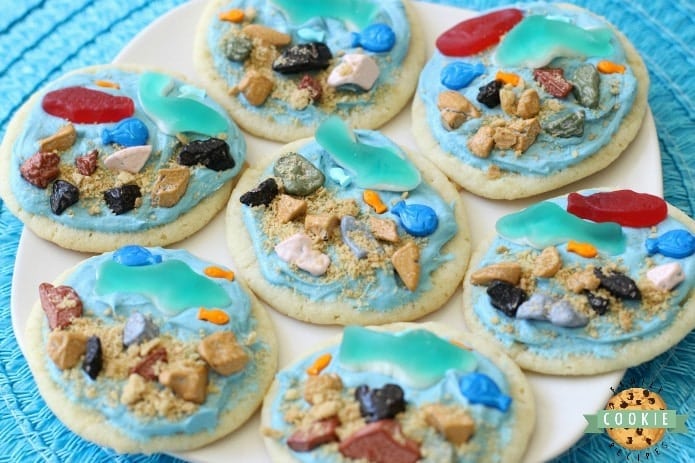 Under the Sea Cookies are soft sugar cookies topped with a fun ocean scene complete with gummy fish & sharks, chocolate rocks and a brown sugar ocean floor! Perfect for celebrating summer at the sea! 