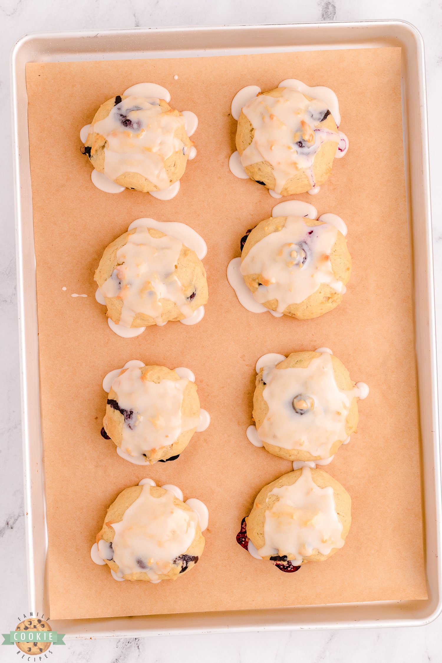 iced blueberry banana cookies on a baking sheet