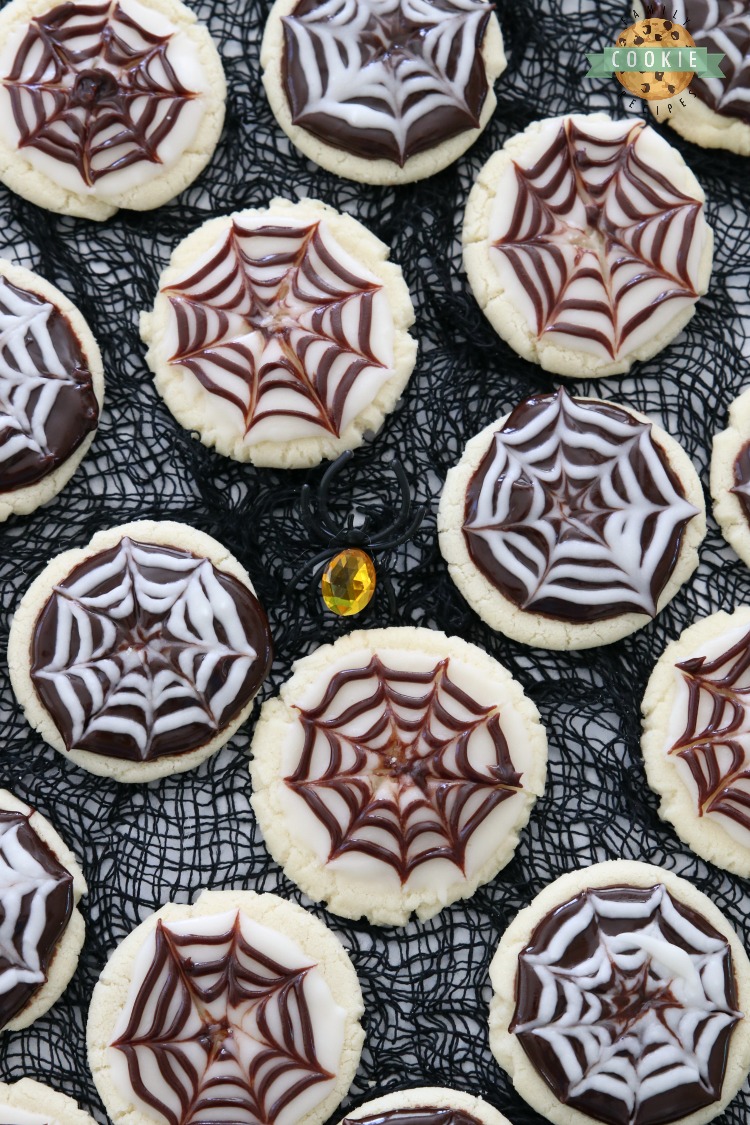 Halloween Cobweb Cookies are spectacularly spooky and completely delicious! Sugar cookies topped with chocolate & vanilla icing- no coloring! Quick & easy spider web design made in seconds. Perfect Halloween treats!