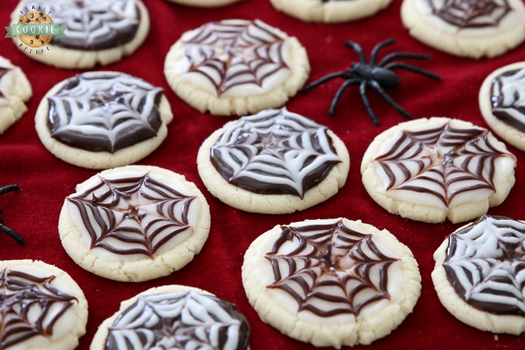 Halloween Cobweb Cookies are spectacularly spooky and completely delicious! Sugar cookies topped with chocolate & vanilla icing- no coloring! Quick & easy spider web design made in seconds. Perfect Halloween treats!