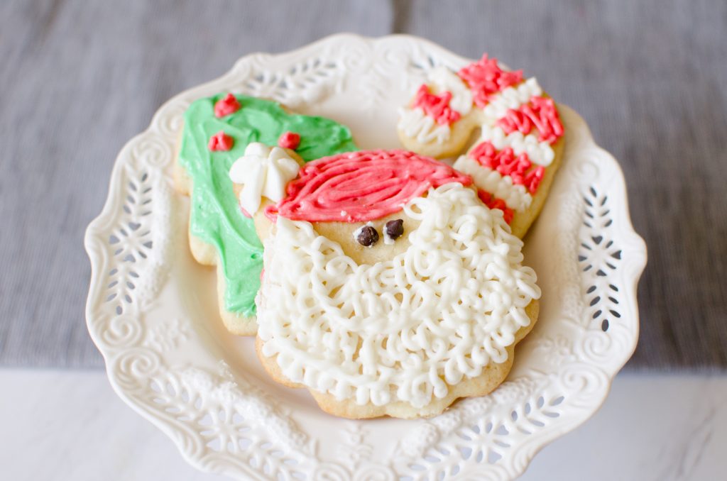 Christmas Sugar Cookies are a necessary holiday tradition at our house! This simple sugar cookie recipe produces soft, chewy and delicious cut-out cookies that can be decorated with a simple 4-ingredient buttercream frosting.