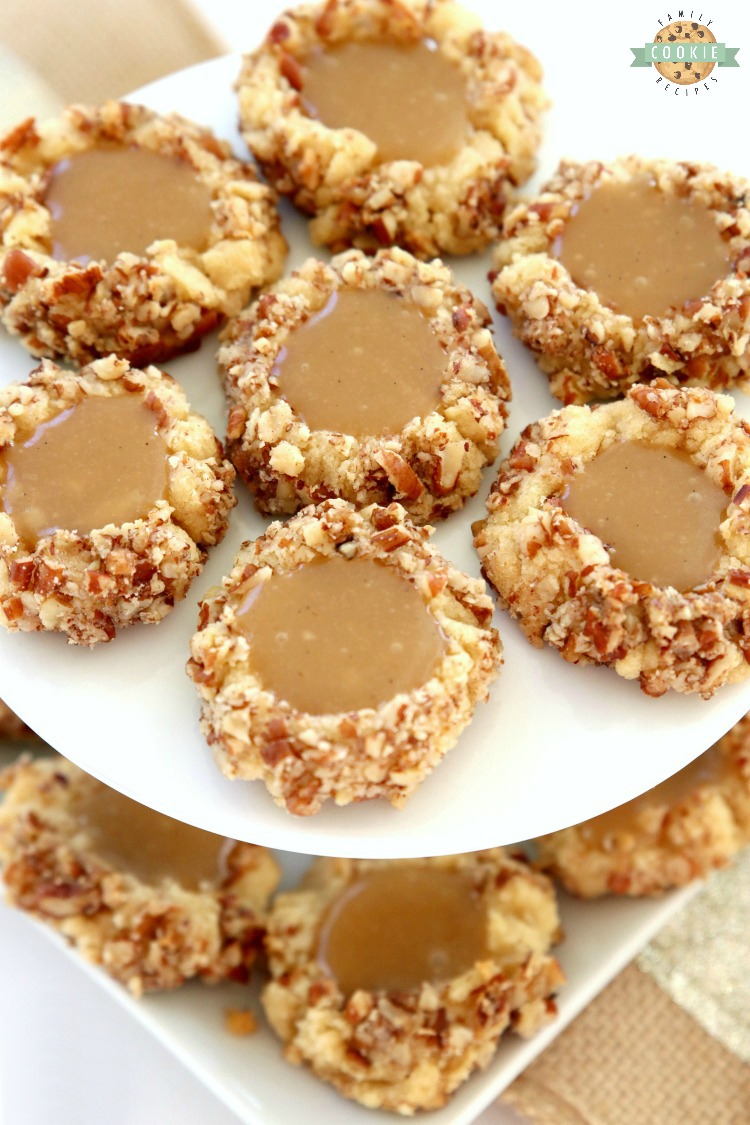 Caramel Thumbprint Cookies are a classic shortbread cookie rolled in pecans, baked & filled with warm caramel. Buttery Christmas cookies that everyone loves seeing at holiday cookie exchanges!