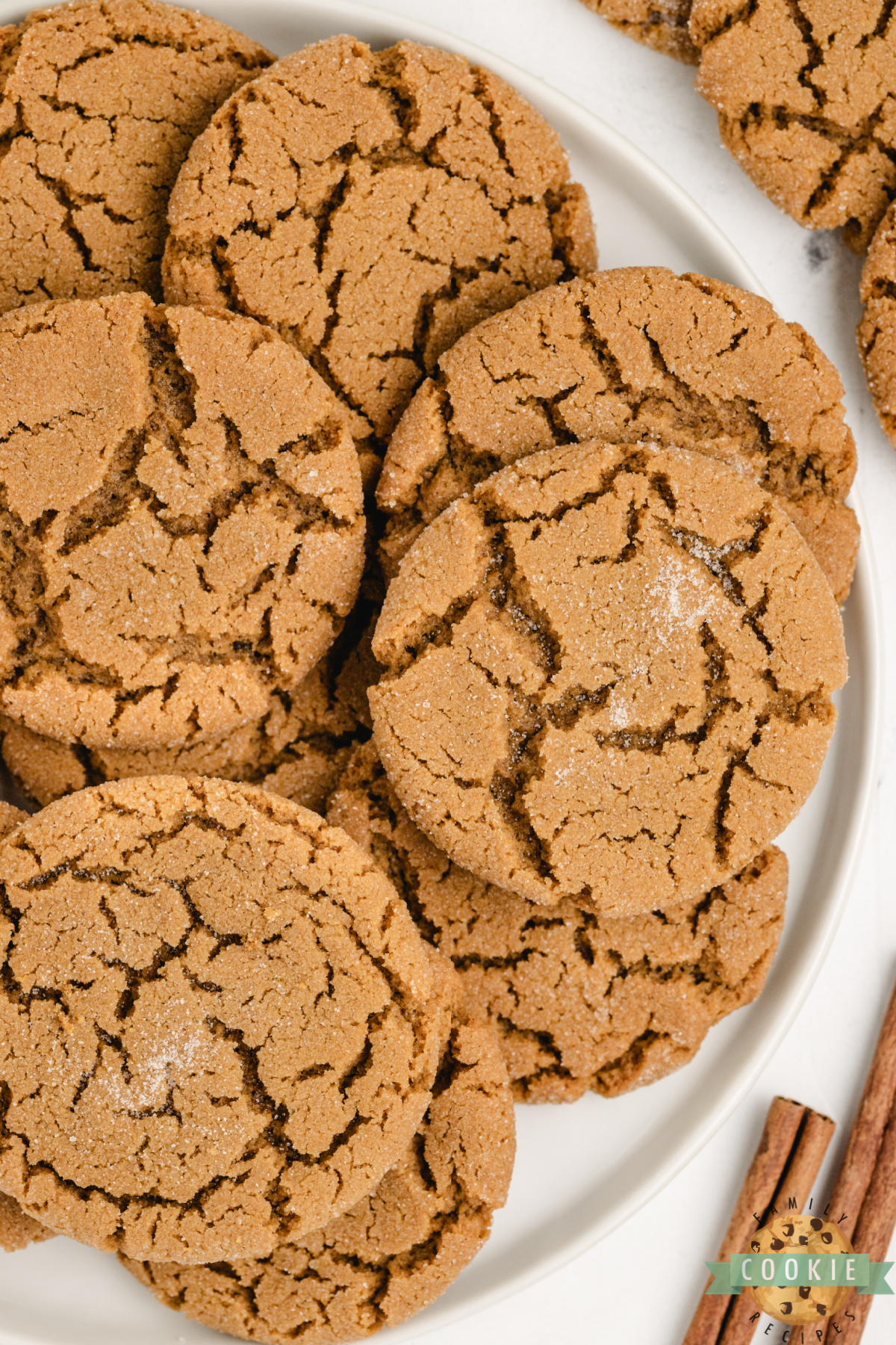 Close-up of soft gingerbread cookies stacked on a plate, showing chewy centers and sugar-dusted tops.