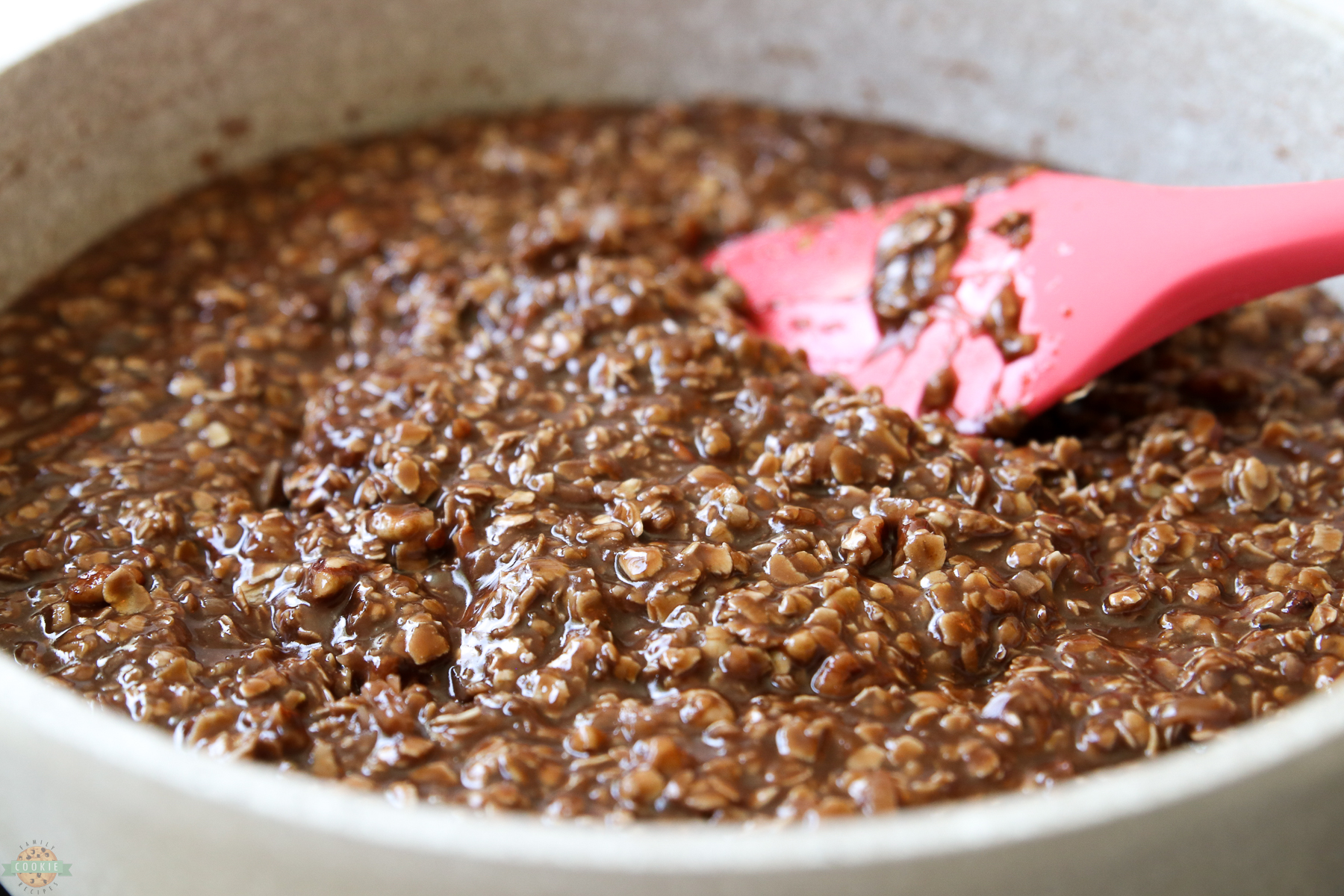stirring no bake cookie mixture in a saucepan on the stove