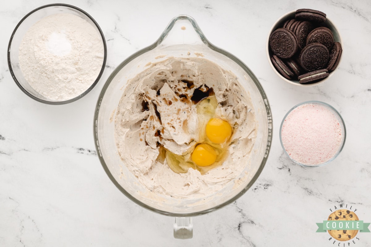 Adding eggs and vanilla to cookie dough. 