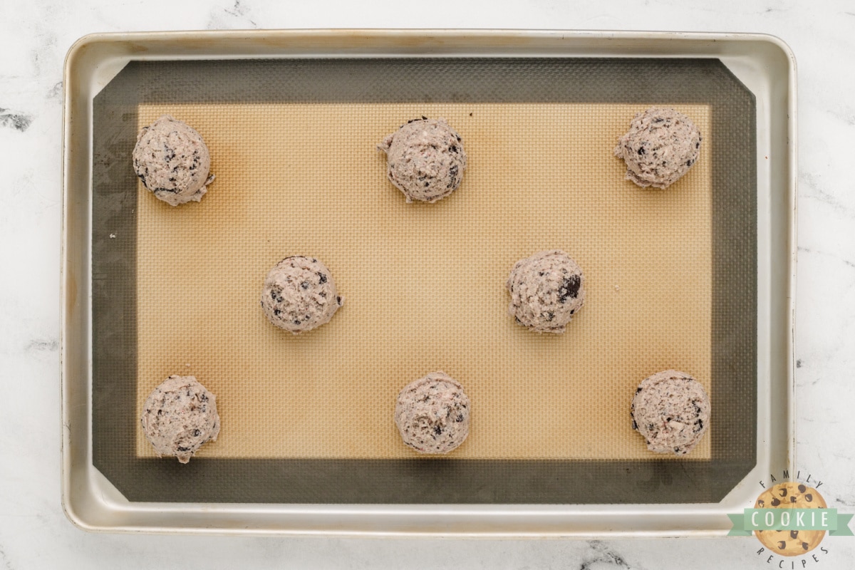 Scooping cookie dough onto cookie sheets. 
