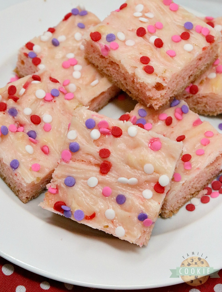 Strawberry Cheesecake Cookie Bars are made with a strawberry cake mix with a simple sweet cream cheese filling swirled in. Only 6 ingredients for these simple cookie bars that are soft, sweet and taste like strawberry cheesecake in cookie form! 