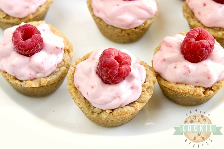 Raspberry Cheesecake Cookie Cups have a raspberry cheesecake filling in a bite-sized graham cracker cookie crust. These delicious cookie cups taste just like raspberry cheesecake and only take a few minutes to make!