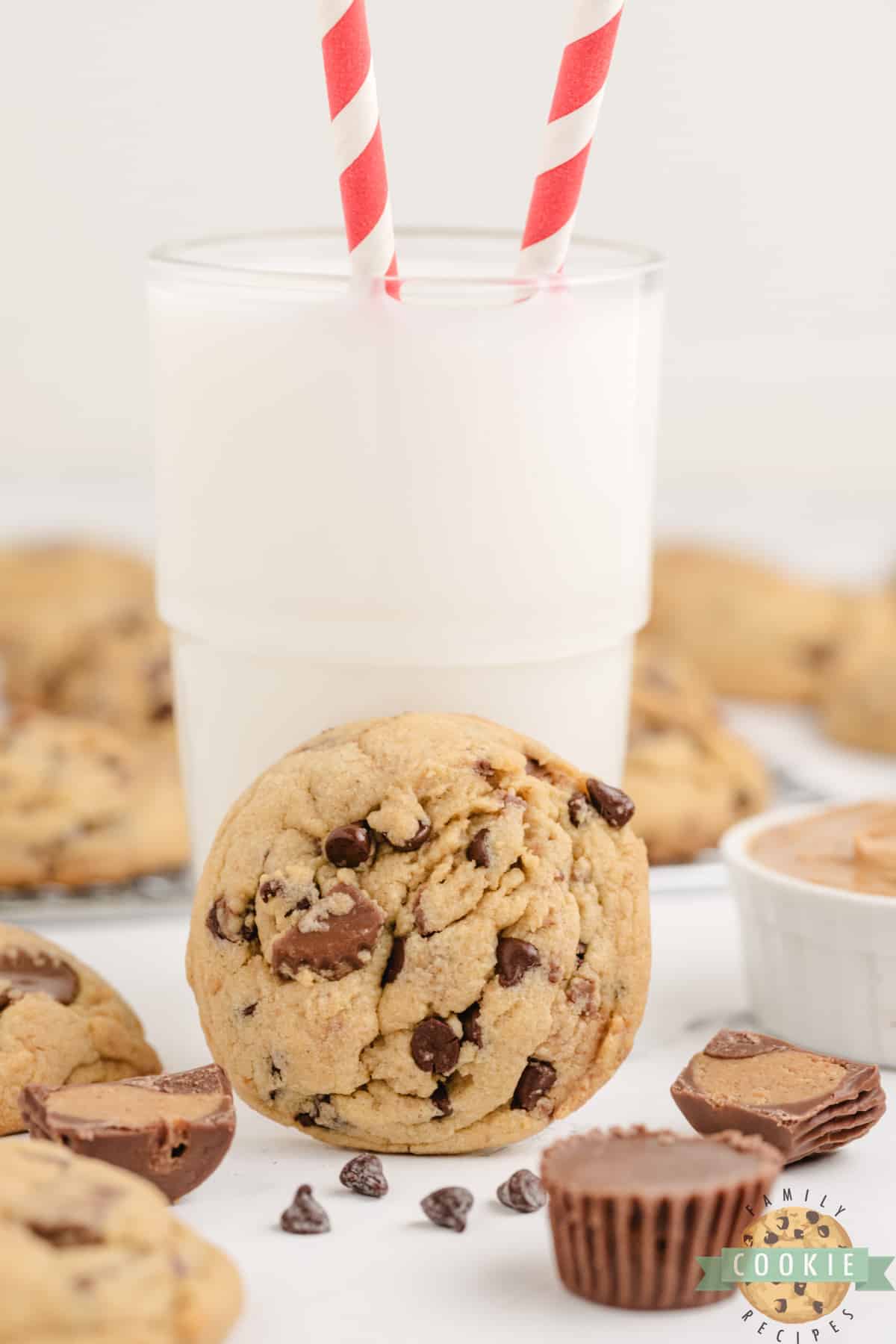 Peanut butter cookie with peanut butter cups and a glass of milk. 