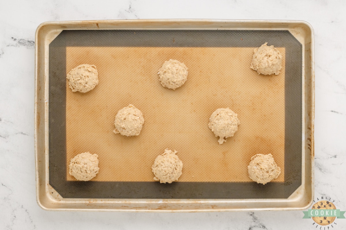 Scoops of cookie dough on cookie sheet. 