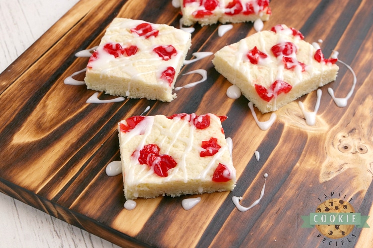 Sugar cookie bar topped with maraschino cherries and glaze