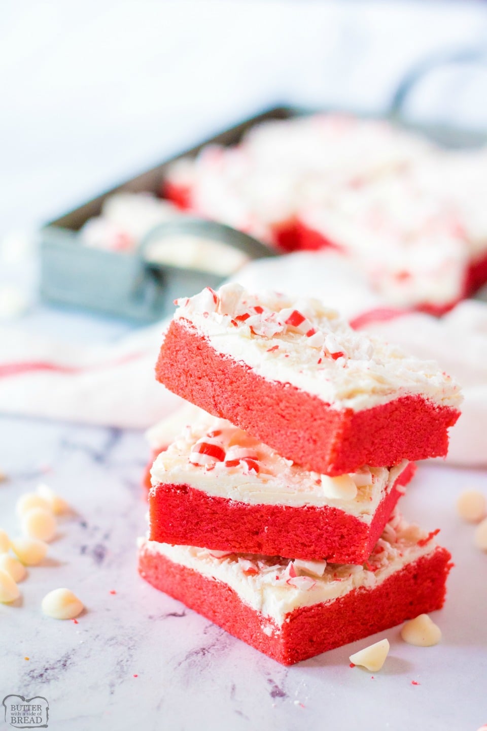 Frosted Peppermint Cookie Bars are festive holiday sugar cookies baked into bars & topped with sweet white chocolate & peppermints! Easy cookie bar recipe with lovely peppermint flavor perfect for Christmas baking. 