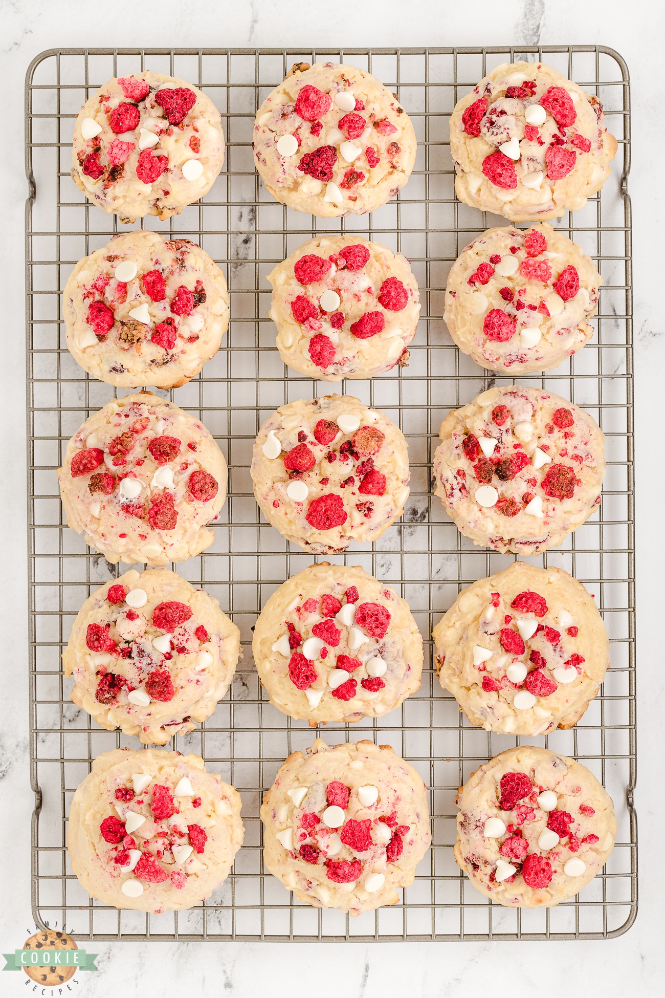 raspberry cheesecake cookies on a cooling rack