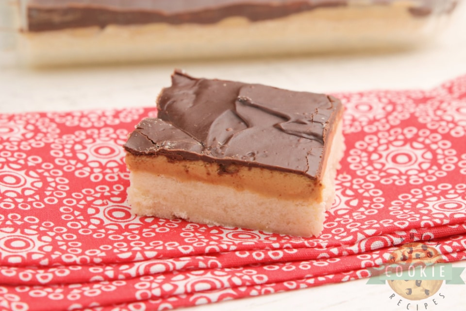 Tagalong Cookie Bars made with a shortbread cookie crust with a peanut butter layer with chocolate on top. Simple to put together, and taste just like your favorite chocolate peanut butter Girl Scout cookies.