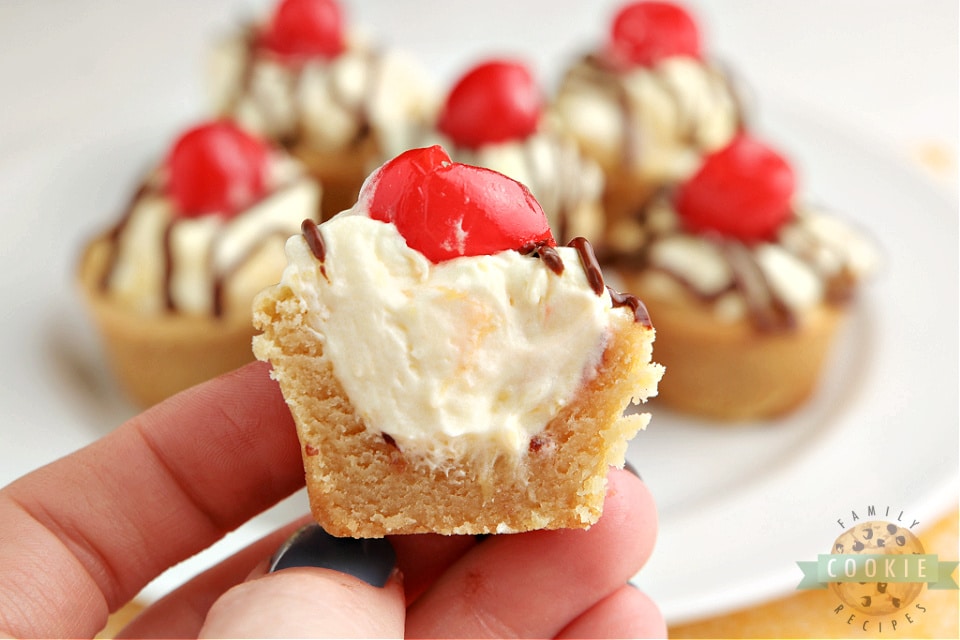 Banana Split Cookie Cups taste like your favorite banana split dessert in cookie form! Banana flavored cookies filled with pineapple cream and topped with chocolate and a cherry! 