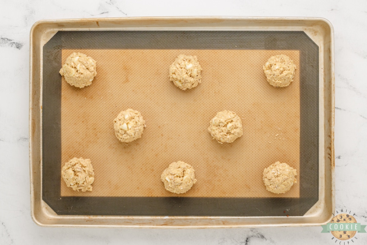 Spoonfuls of cookie dough on cookie sheet. 