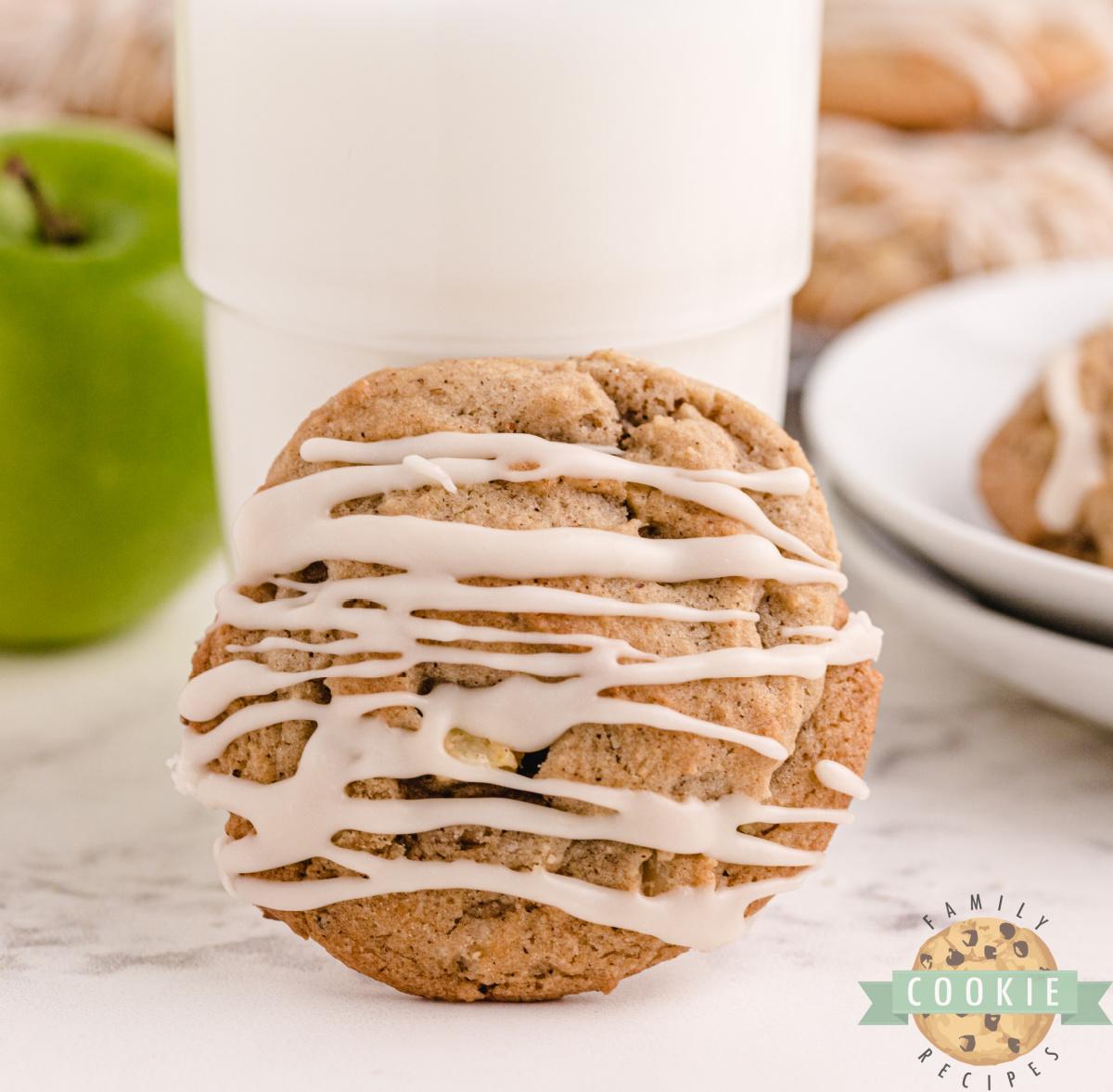 Vanilla Glazed Spiced Apple Cookies are soft, chewy cookies with apples, warm spices, and walnuts, finished with a sweet vanilla glaze.