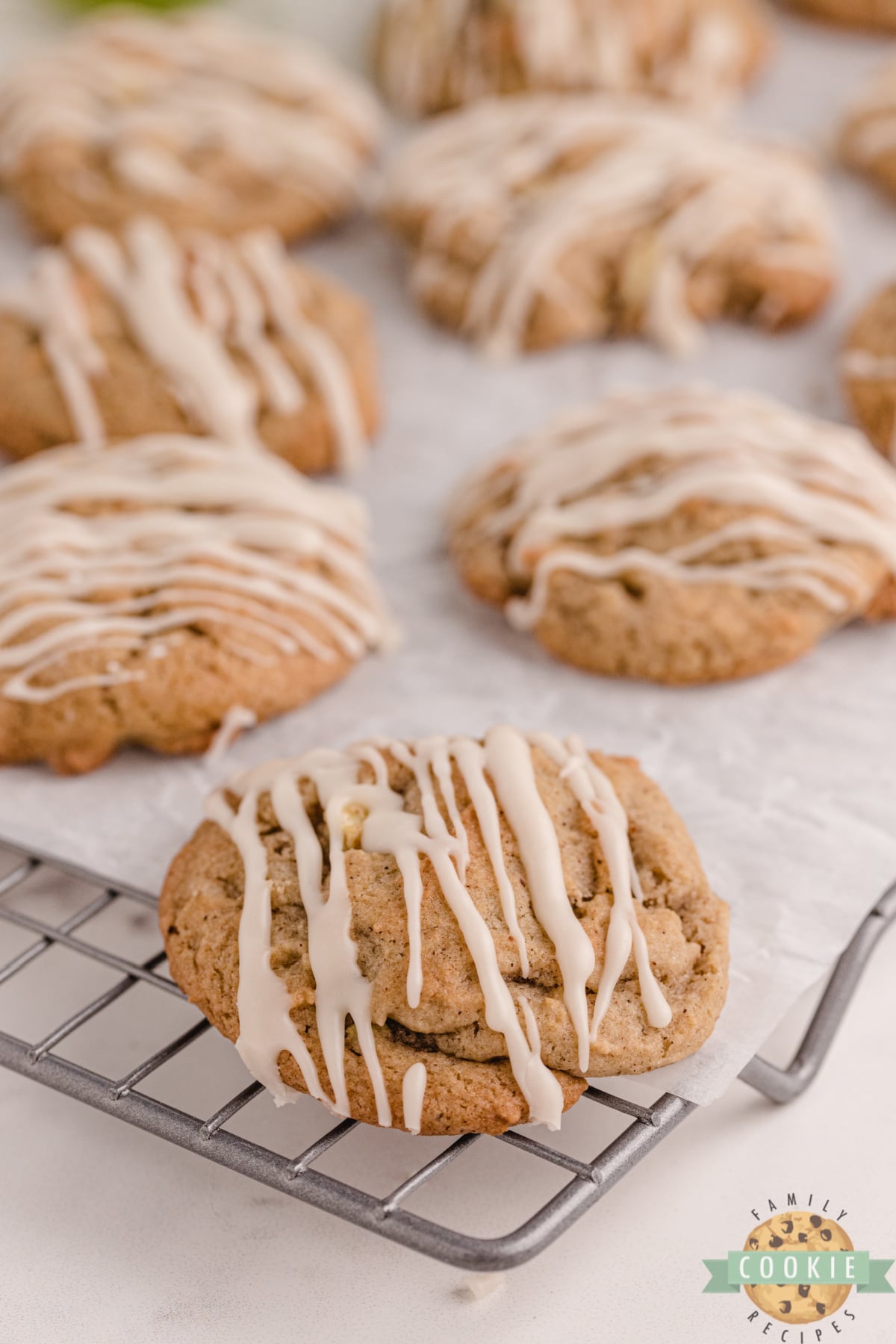 Vanilla Glazed Spiced Apple Cookies made with lots of spices, fresh apples and walnuts. Soft and chewy cookie recipe that is topped with a simple vanilla glaze.