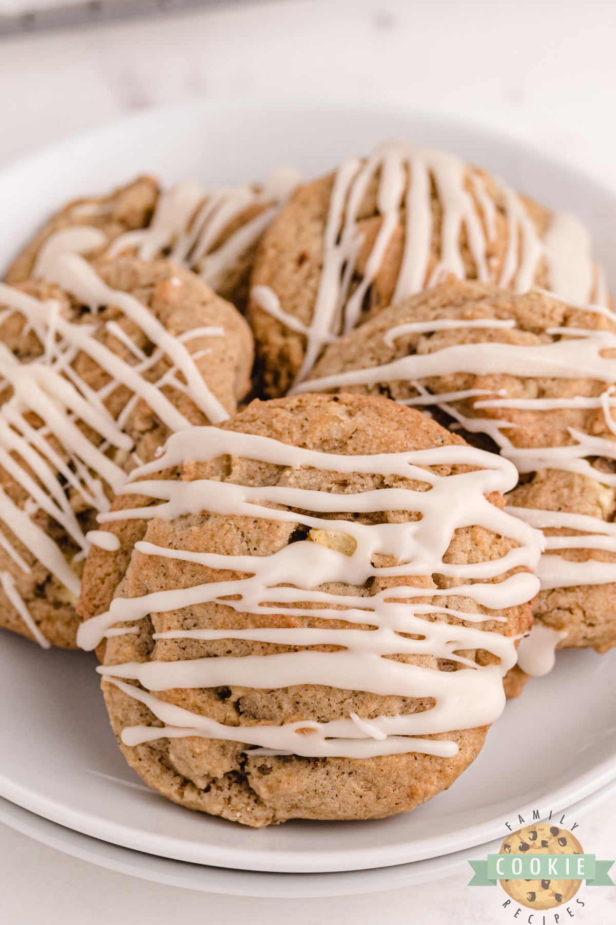 Vanilla Glazed Spiced Apple Cookies made with lots of spices, fresh apples and walnuts. Soft and chewy cookie recipe that is topped with a simple vanilla glaze.