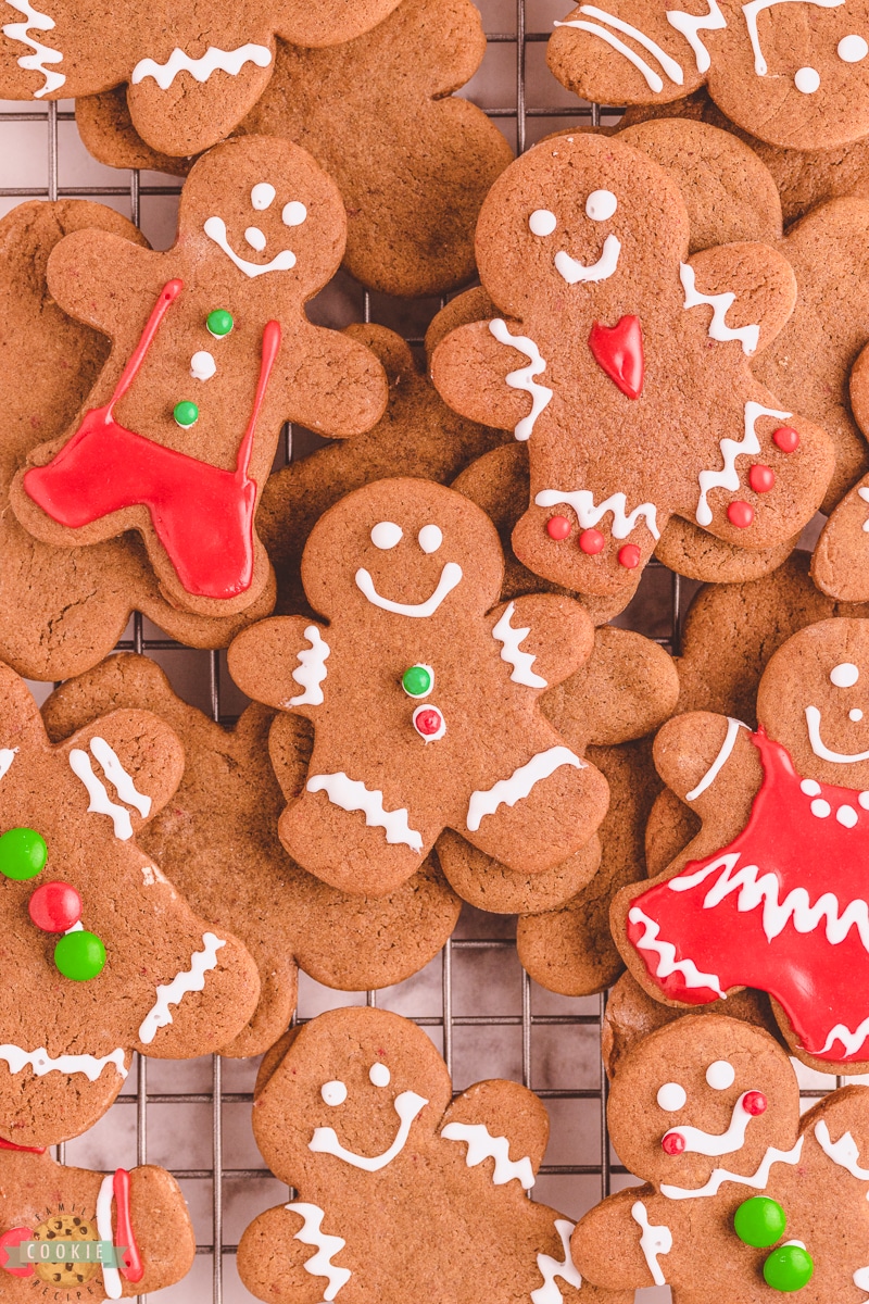 decorated gingerbread cookies piled on a cooling rack