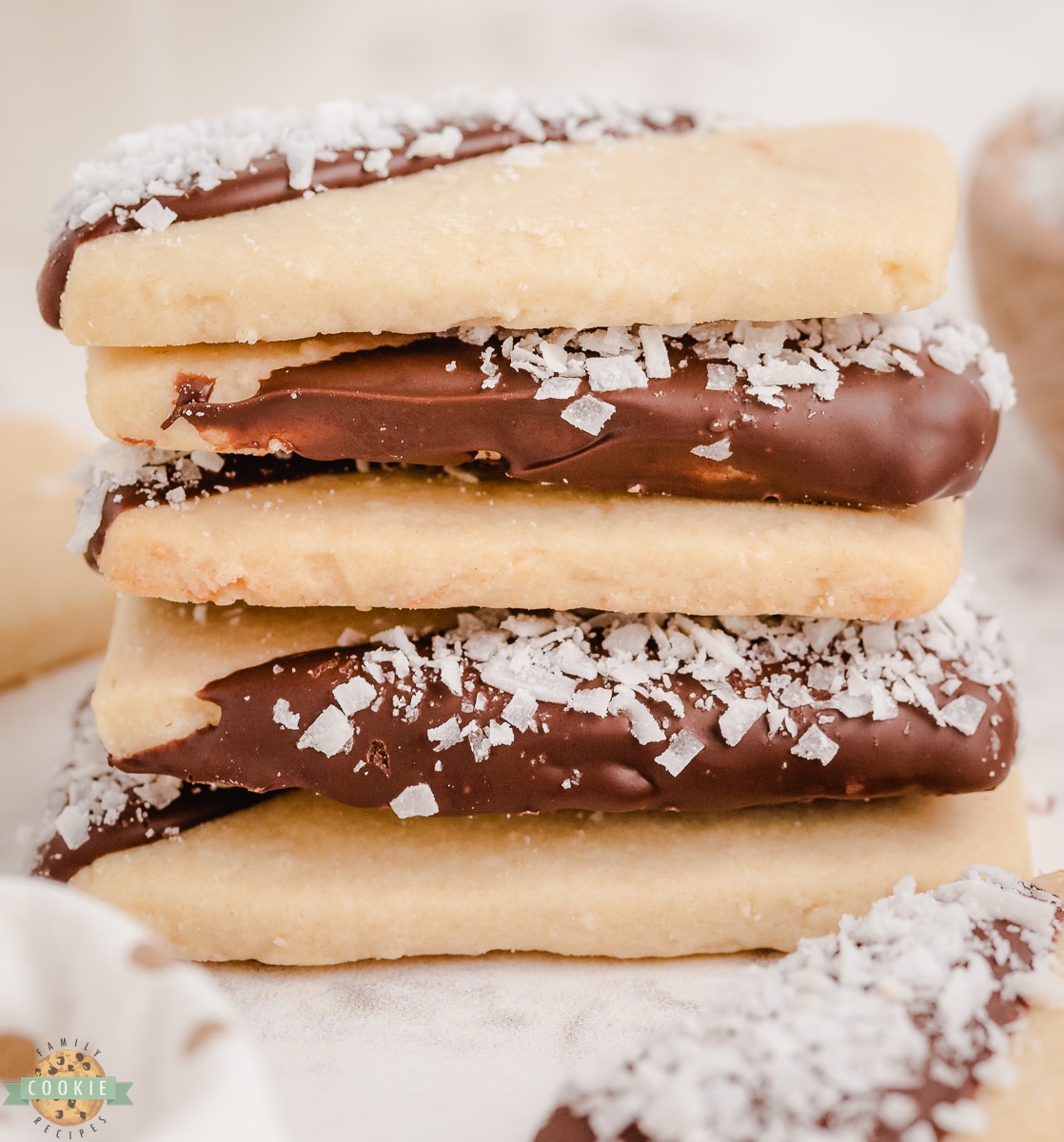 stacked coconut shortbread cookies that were dipped in chocolate