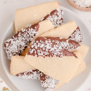 chocolate dipped coconut shortbread cookies in a stack