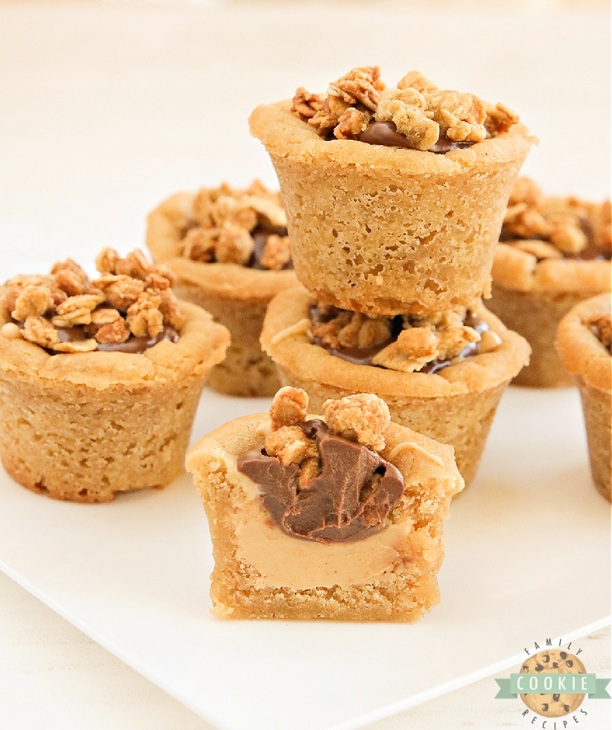 Peanut butter cookie cups filled with peanut butter, chocolate and granola