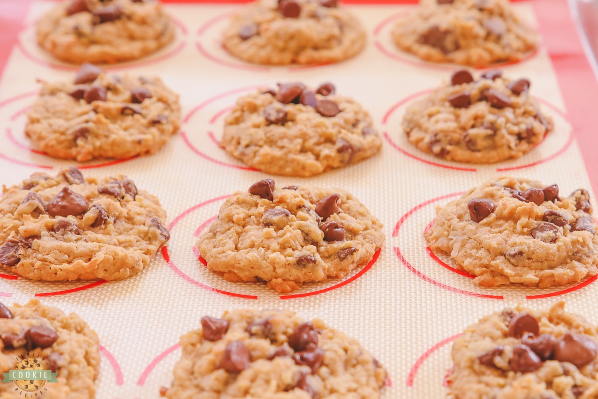 chocolate chip cookies with coconut and oatmeal on a silicon baking mat