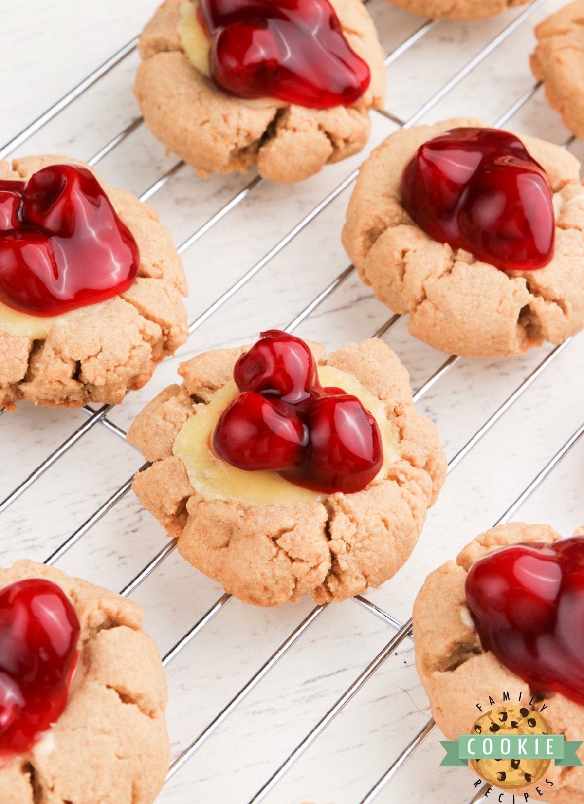 Cheesecake Cookies are graham cracker cookies baked with a simple cheesecake filling and topped with your favorite fruit or pie filling. 