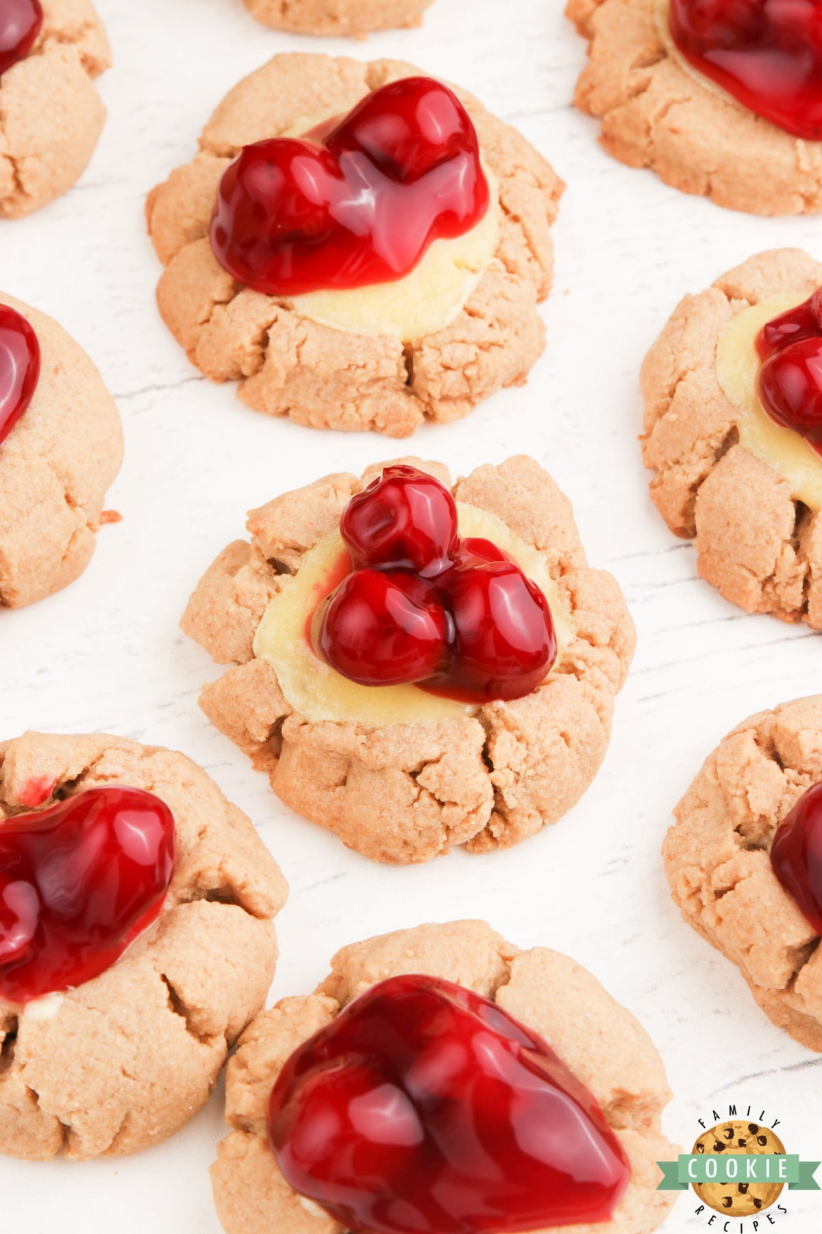 Graham cracker cookies with a cheesecake filling and cherries on top