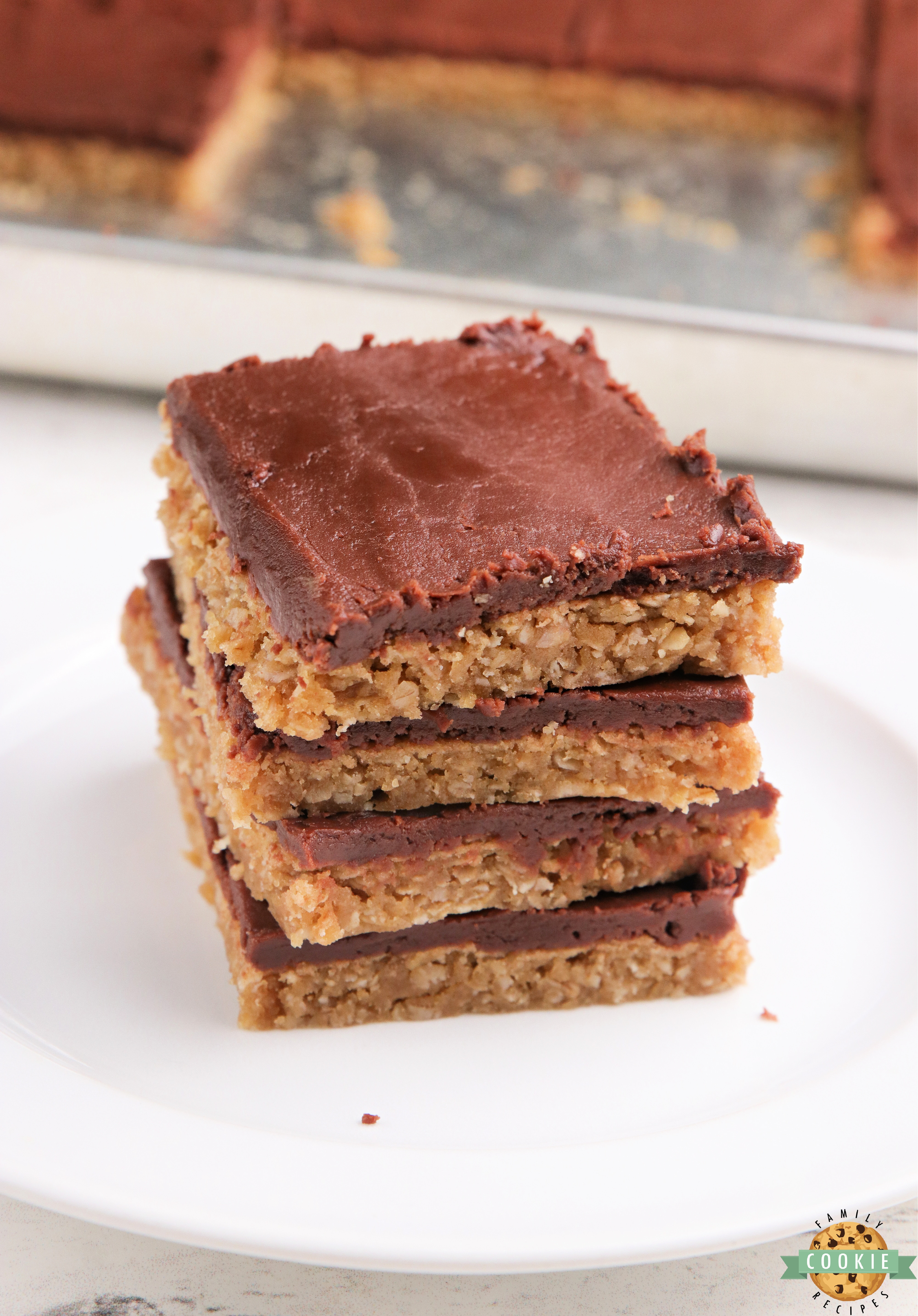 Peanut Butter Cookie Bars are soft and chewy with a chocolate fudge frosting on top. Delicious cookie bar recipe made with peanut butter, oats and a simple chocolate ganache for the frosting!