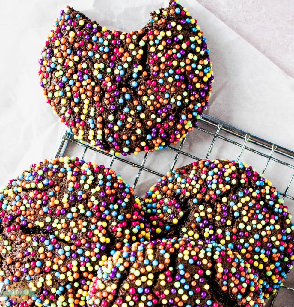 chocolate sprinkle cookies with a bite taken out