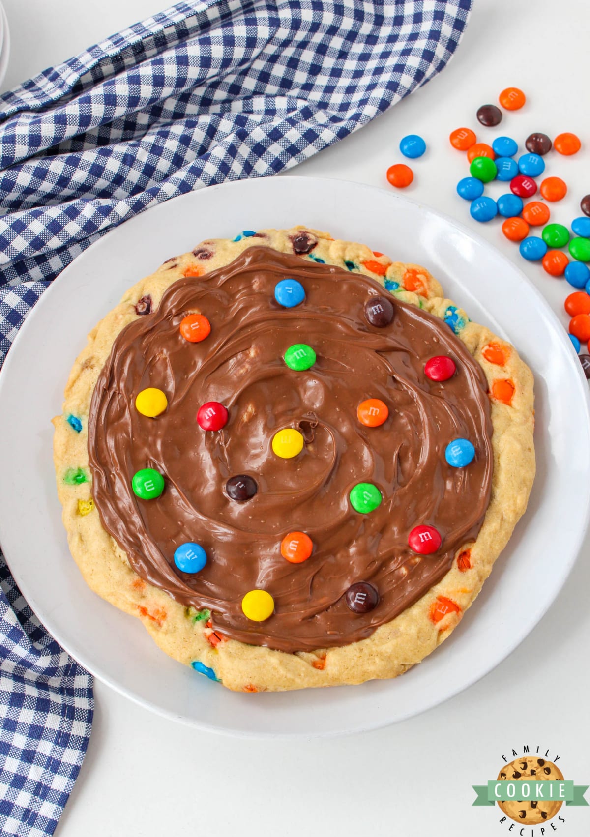 M&M Cookie Pizza is soft, chewy and covered in chocolate. This skillet cookie recipe is easy to make completely from scratch and everyone will love it! 