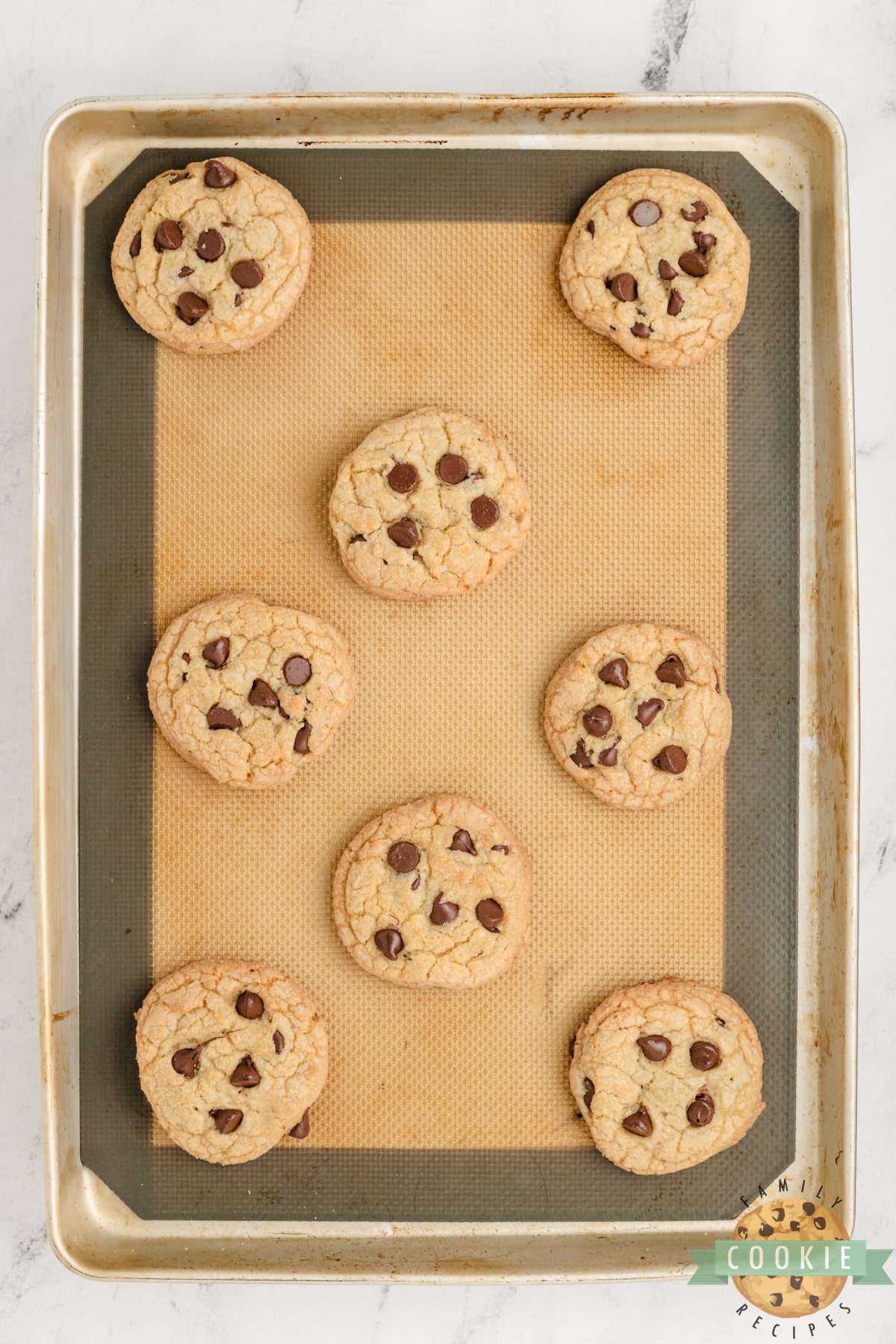 Baked cookies on cookie sheet lined with silicone baking mat.