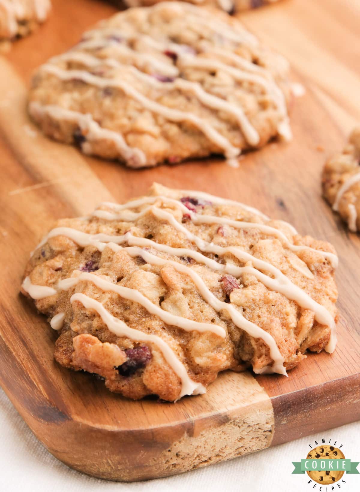 Glazed Pomegranate Oatmeal Cookies are soft, chewy and packed with the flavor of maple syrup, cinnamon, pomegranate seeds and pecans. Delicious oatmeal cookies topped with a simple maple syrup glaze. 