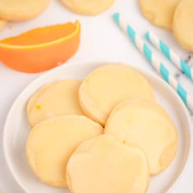 orange shortbread cookies on a white plate