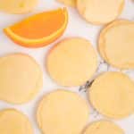 iced orange shortbread cookies with an orange slice