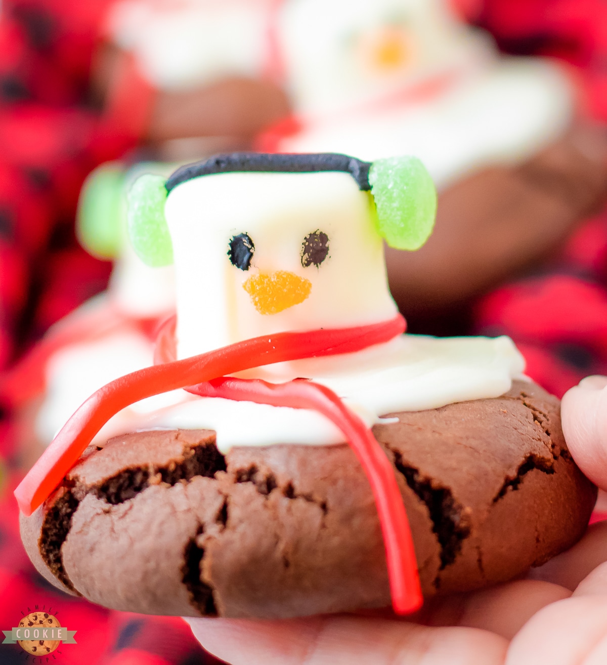 holding a peppermint snowman cookie