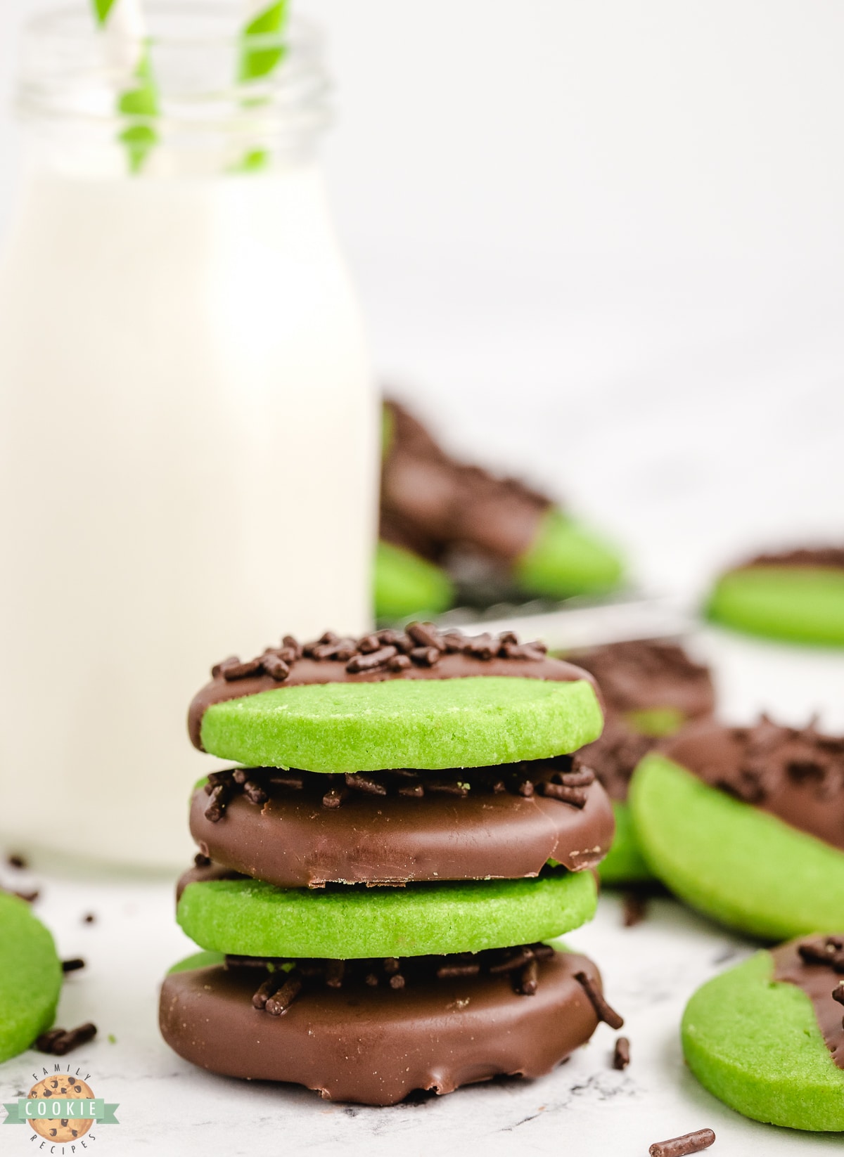 stack of green shortbread cookies with milk