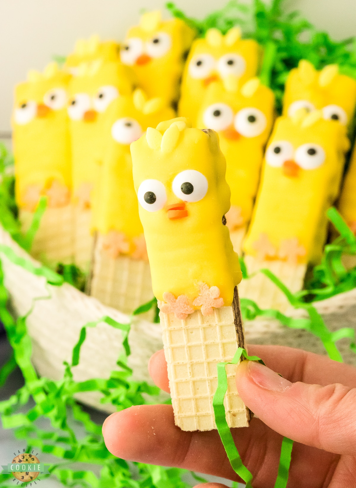 holding up an Easter chick cookie