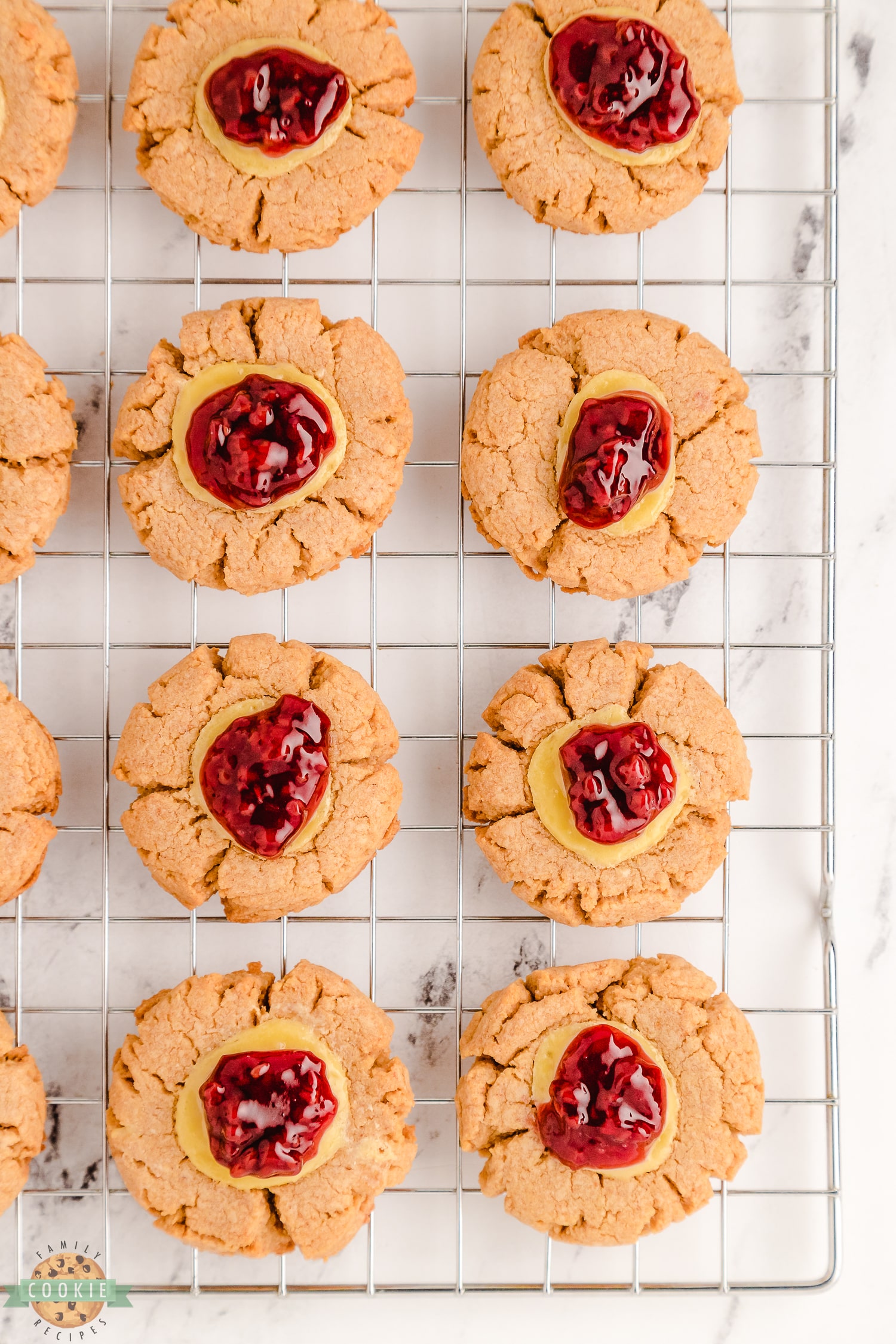 raspberry cheesecake cookies on a cooling rack