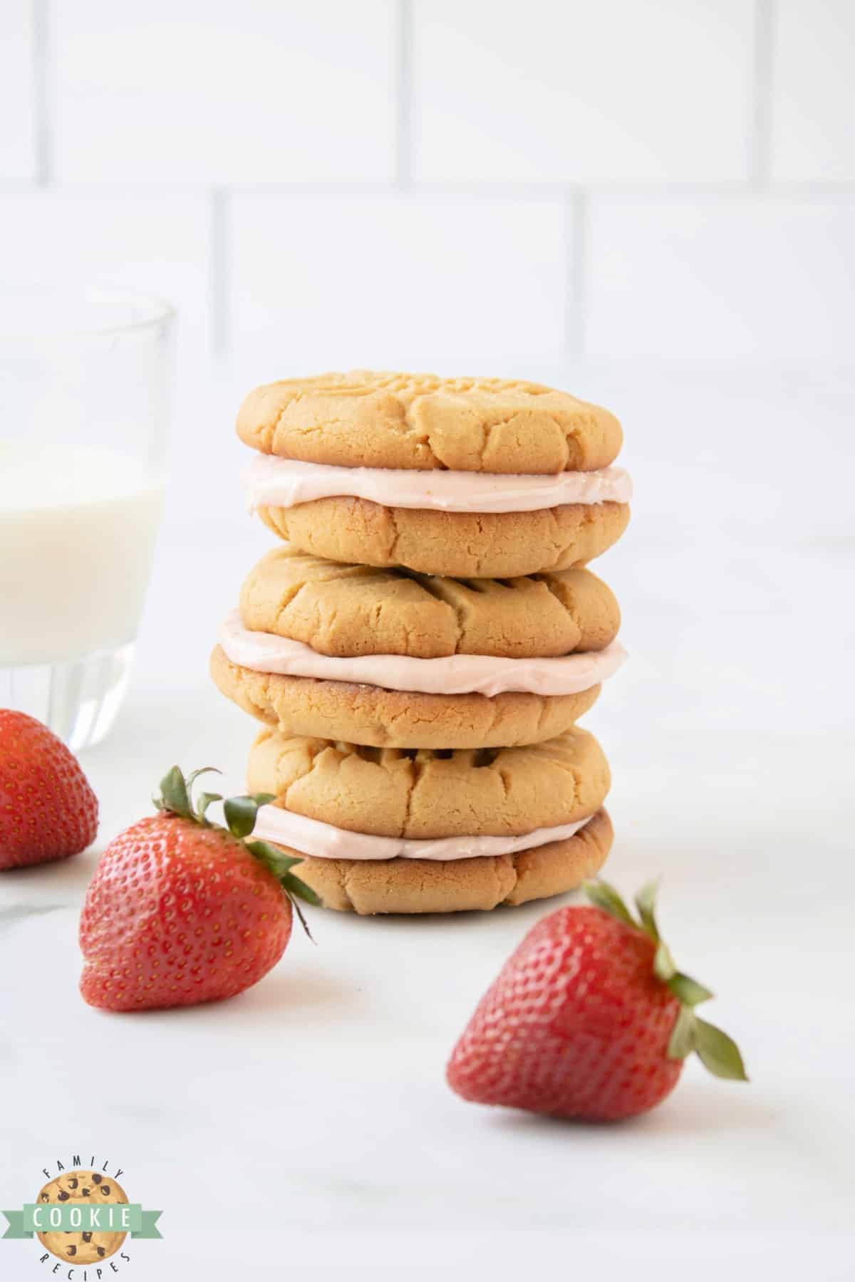 Peanut Butter and Jelly Sandwich Cookies are made by spreading a creamy strawberry buttercream frosting between two soft and chewy peanut butter cookies.  Your favorite childhood sandwich in the form of a dessert that everyone loves! 